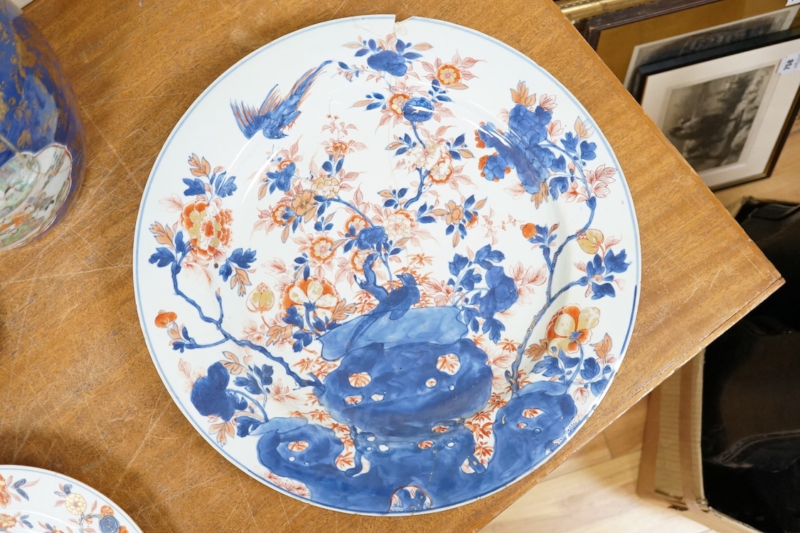 Three early 18th century Chinese Imari dishes (one clobbered), largest 46.5cm, together with a 19th century Chinese powder blue ground vase, 44cm high and a horn carving, 13.7cm (5)